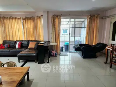 Spacious living room with modern furniture and large windows for natural light.