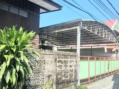 Charming residential property with gated entrance and spacious carport in sunny neighborhood.