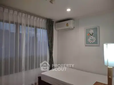 Cozy bedroom with air conditioning and elegant decor, perfect for relaxation.