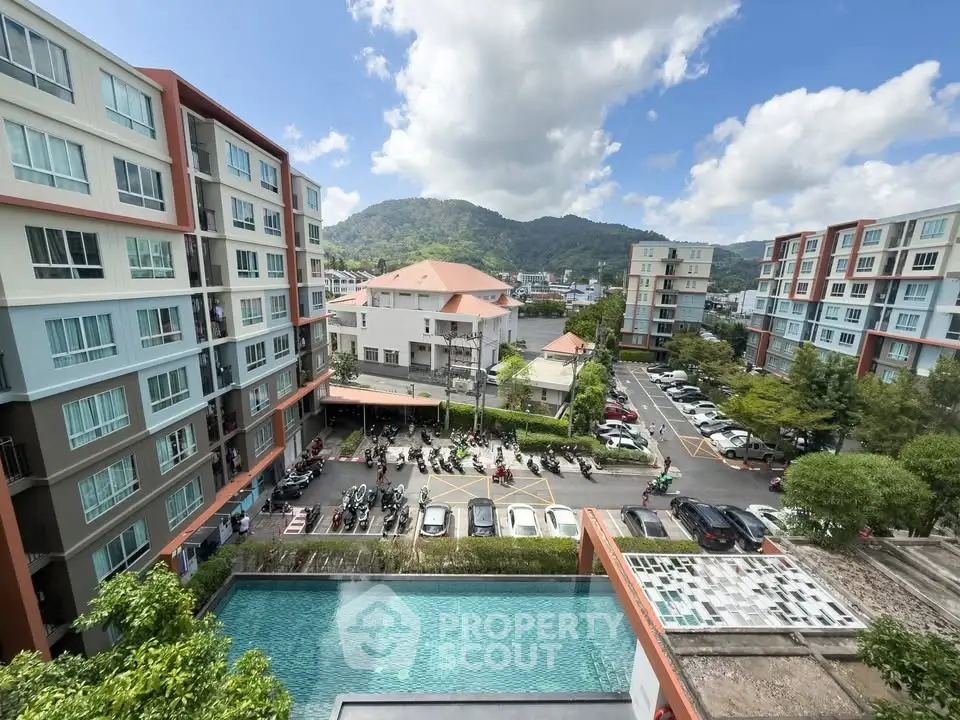Stunning view of modern apartment complex with pool and mountain backdrop