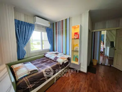 Charming bedroom with colorful striped wall and cozy bed in modern home