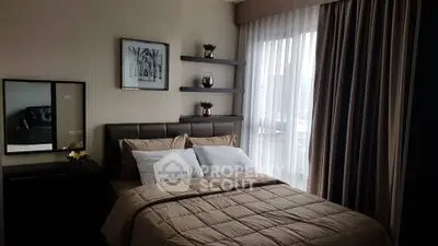 Cozy bedroom with elegant decor and natural light from large window