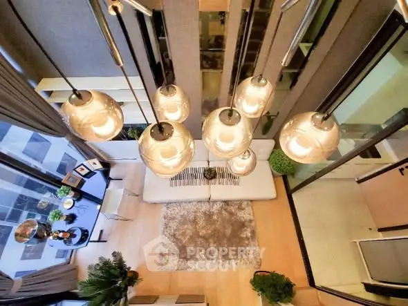 Stunning modern living room with high ceiling and elegant lighting fixtures.