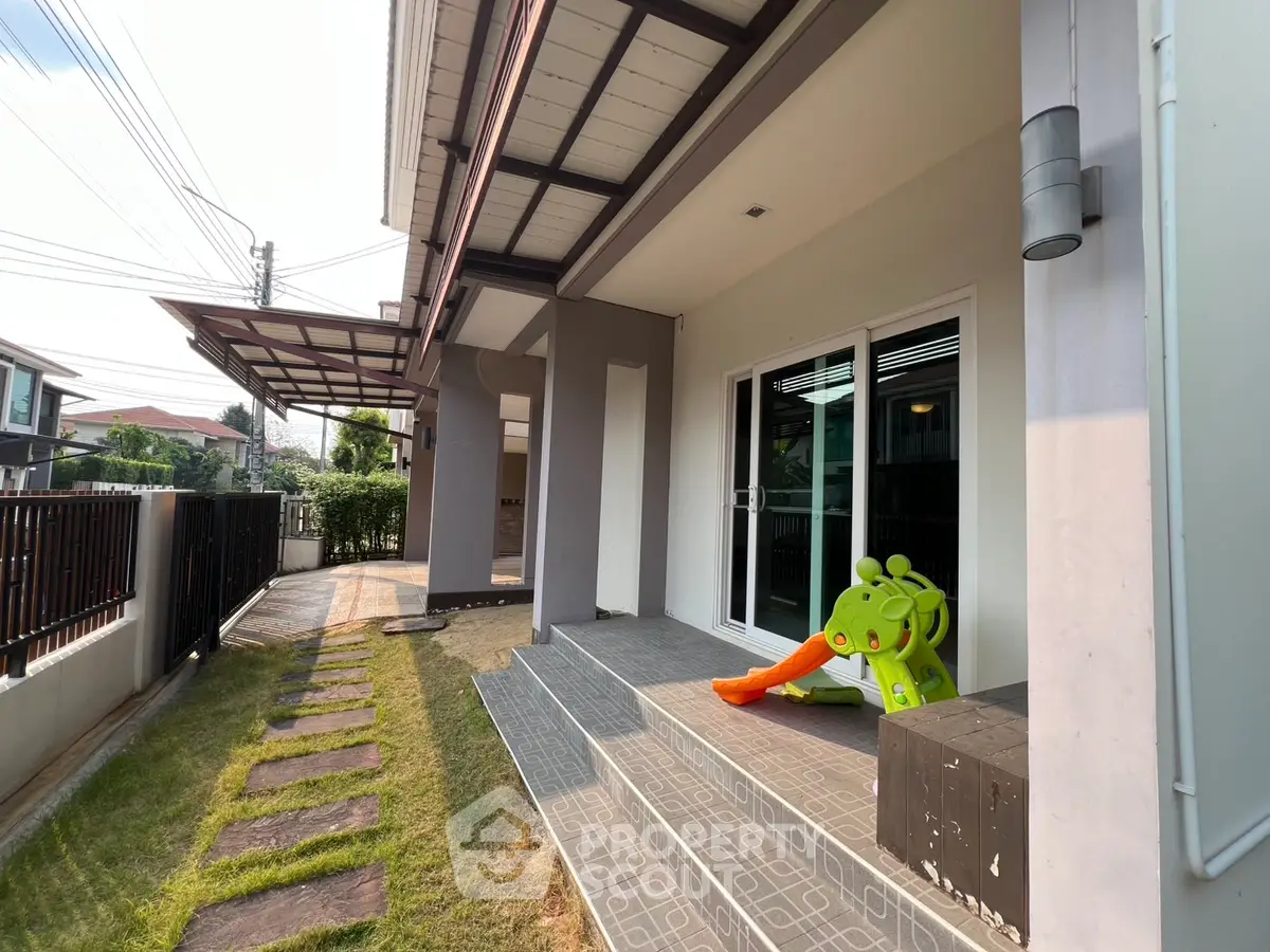 Charming modern home exterior with patio and garden, perfect for family living.