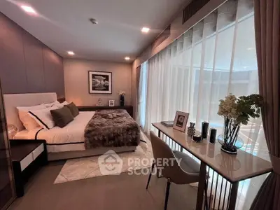 Luxurious bedroom with elegant decor and natural light, featuring a cozy bed and stylish workspace.