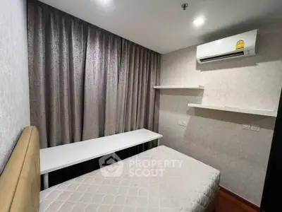 Cozy bedroom with modern air conditioning and elegant curtains, perfect for restful nights.