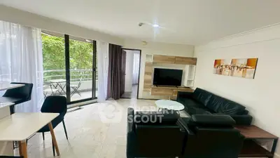 Spacious living room with modern furniture and balcony view, perfect for relaxation and entertainment.