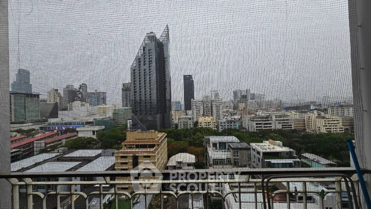 Stunning cityscape view from a high-rise balcony with modern architecture.