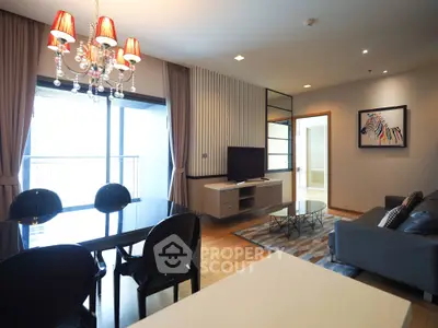 Modern living room with elegant chandelier and spacious balcony view