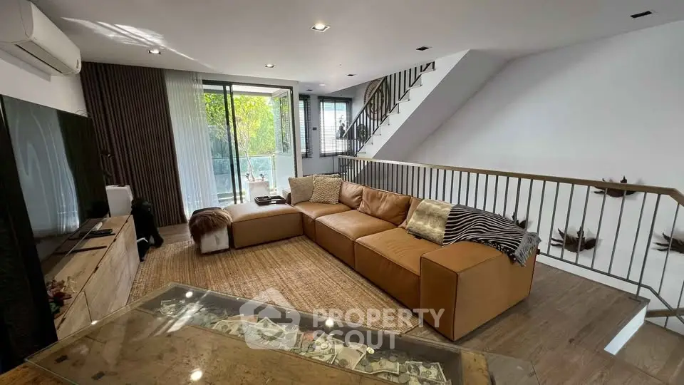 Spacious modern living room with large leather sofa and stylish decor