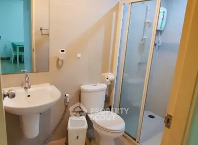 Modern bathroom with shower and sleek fixtures in a cozy apartment.