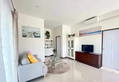Bright and airy living room with modern decor and air conditioning.