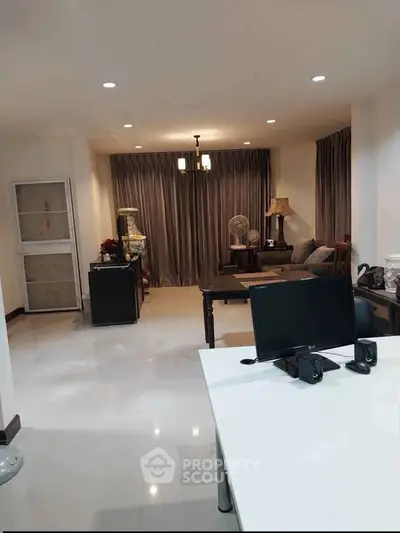 Spacious living room with modern decor and ample natural light