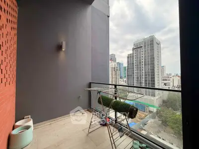 Spacious balcony with city view in modern high-rise apartment