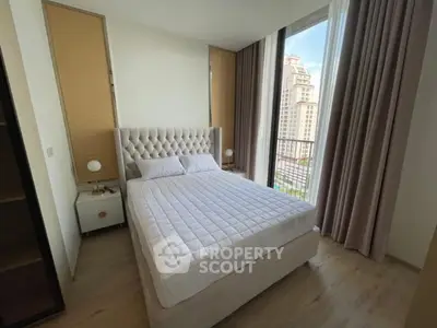 Luxurious bedroom with plush bed and stunning city view from large window.