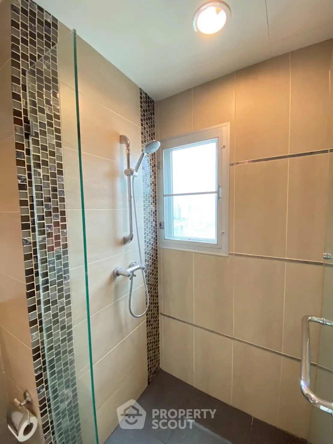 Modern bathroom with sleek shower design and natural light window
