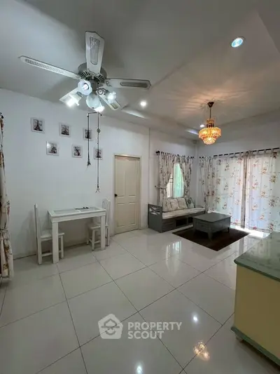 Charming living room with elegant decor and natural light, perfect for relaxation.