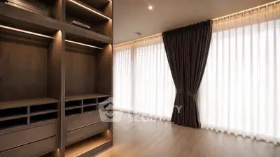 Spacious modern walk-in closet with elegant wooden shelving and natural light.