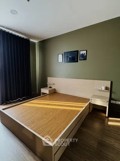 Modern minimalist bedroom with wooden bed frame and dark curtains