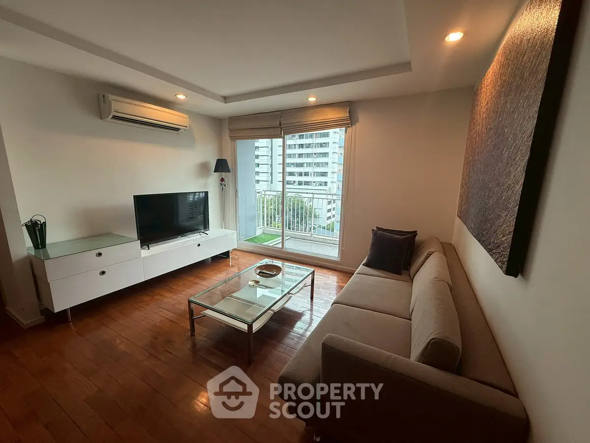 Modern living room with sleek furniture and city view balcony