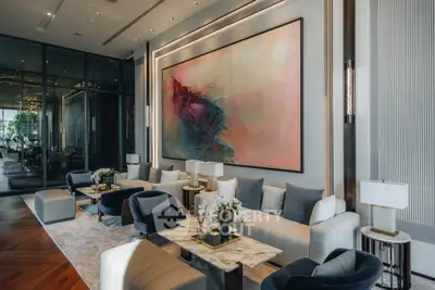 Luxurious modern living room with elegant decor and large abstract painting.