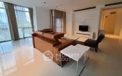 Spacious modern living room with leather sofa and large windows