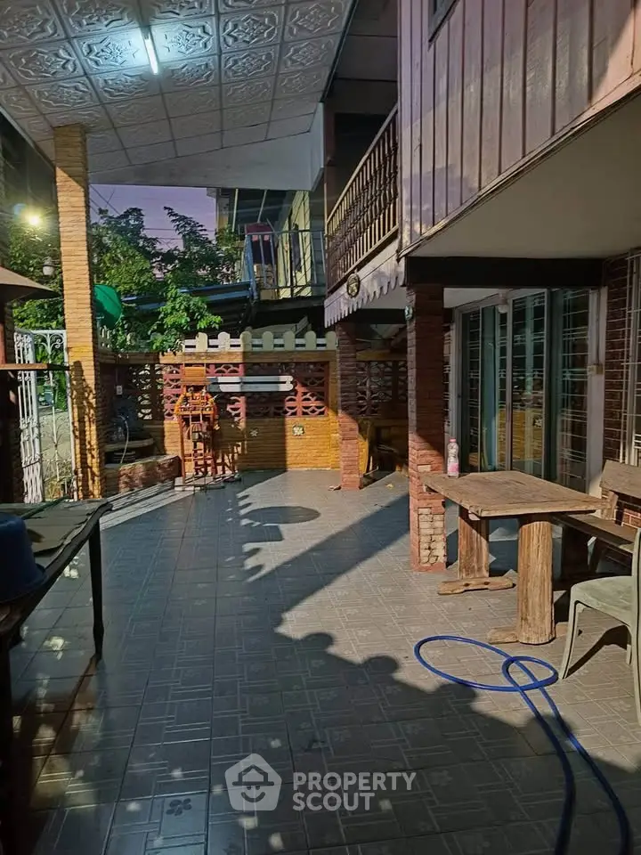 Charming outdoor patio with rustic wooden furniture and brick accents, perfect for relaxation and gatherings.