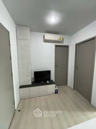 Modern minimalist living room with air conditioning and sleek TV setup