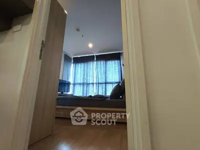 Cozy bedroom with modern decor and large windows in a stylish apartment.