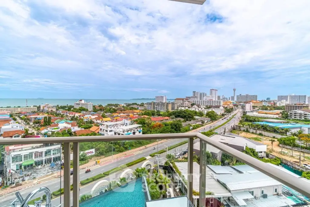Stunning high-rise balcony view overlooking cityscape and ocean horizon, perfect for urban living enthusiasts.