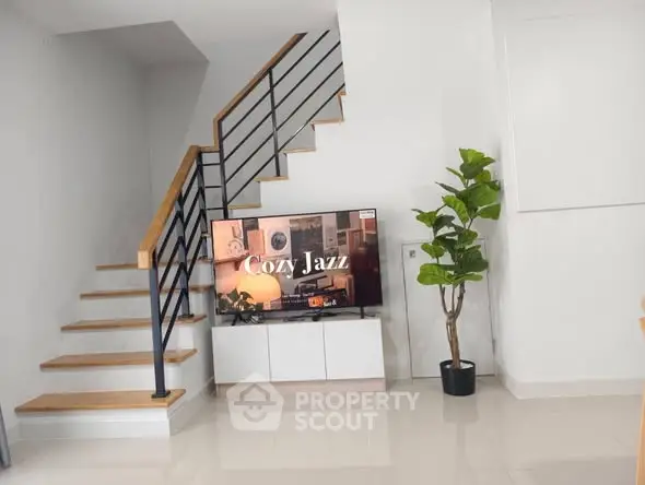 Modern living room with stylish staircase and cozy jazz ambiance on TV