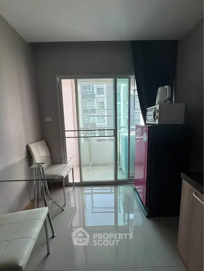 Modern apartment with sleek glass table and balcony view