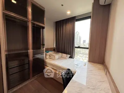 Modern bedroom with city view, featuring sleek wooden furniture and a marble desk.