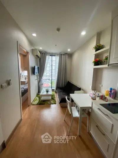 Cozy living room with modern decor and natural light in a stylish apartment.