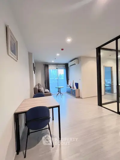 Spacious modern living room with large windows and stylish furniture
