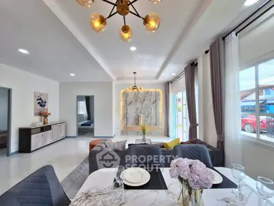 Elegant open-plan living and dining area with modern decor and natural light.