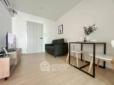 Modern living room with sleek furniture and minimalist decor in a cozy apartment.