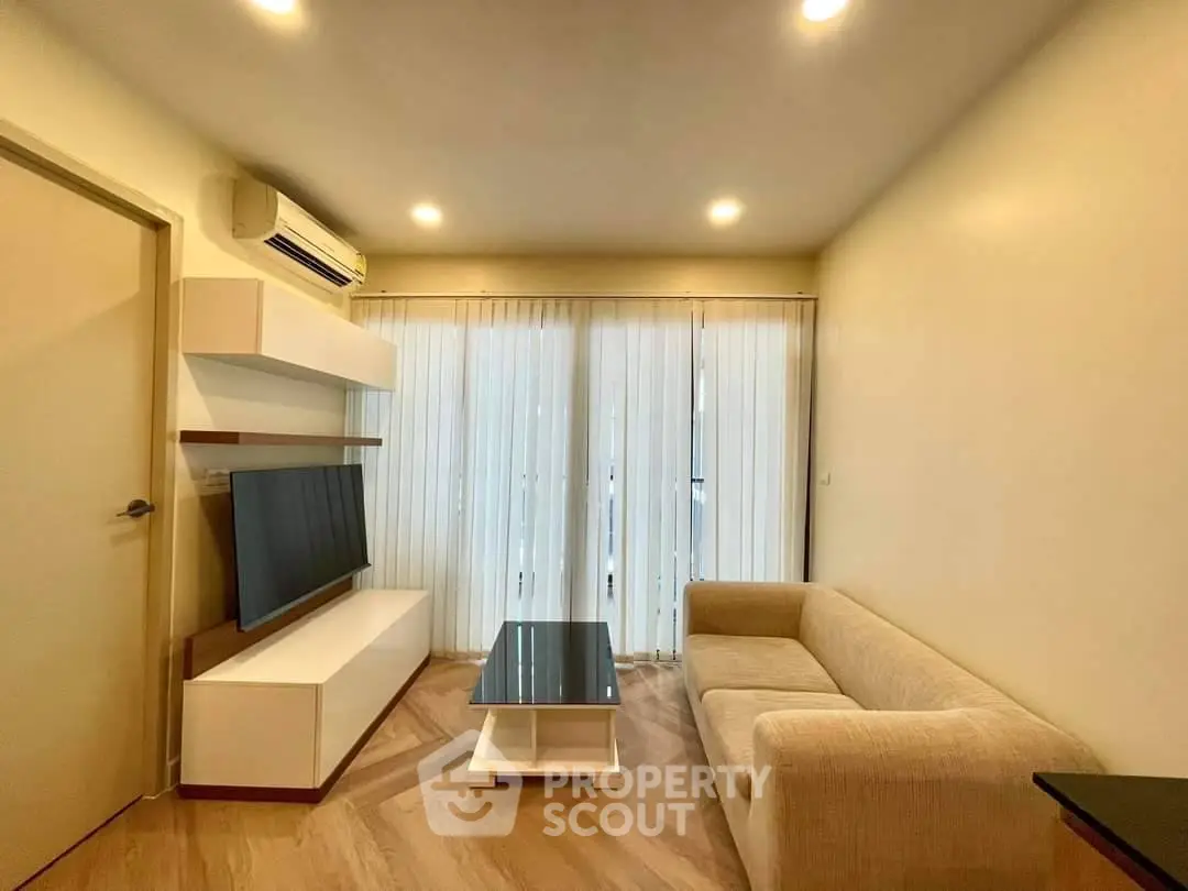 Modern living room with sleek furniture and natural light, perfect for relaxation and entertainment.