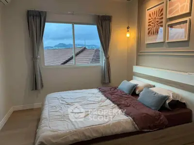 Cozy bedroom with mountain view, featuring elegant decor and natural light.