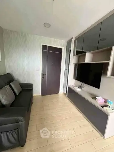 Modern living room with sleek furniture and stylish entertainment unit.