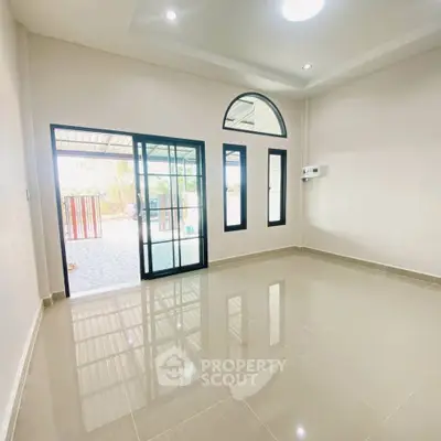Spacious empty room with large windows and glossy tiled floor, perfect for customization.