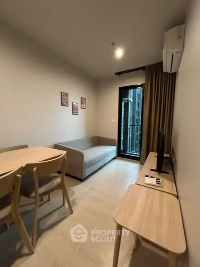 Modern living room with sleek furniture and balcony access