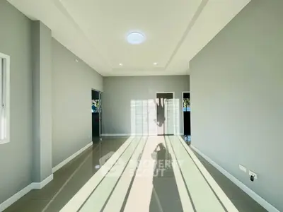 Spacious modern living room with natural light and sleek tile flooring
