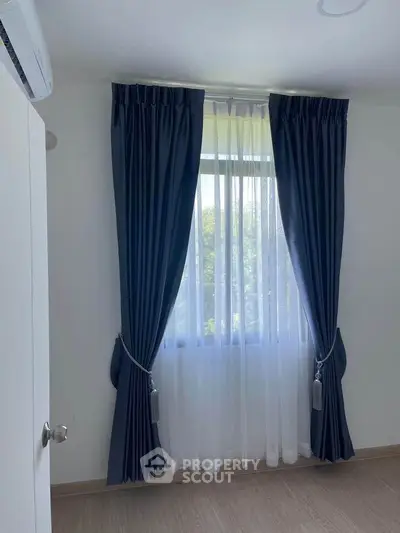 Bright bedroom with elegant blue curtains and natural light