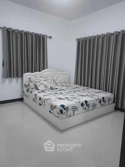 Modern bedroom with Mickey Mouse themed bedding and elegant curtains