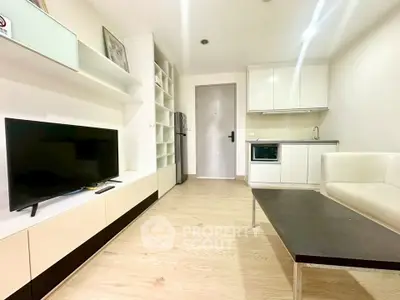 Modern living room with sleek furniture and integrated kitchen in a stylish apartment.