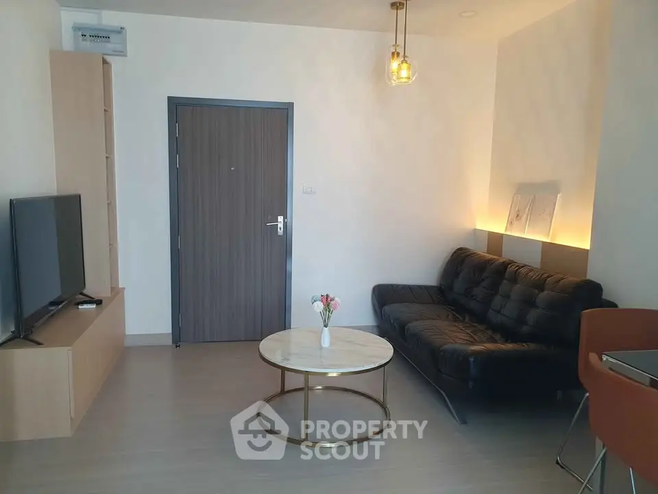 Modern living room with sleek black sofa and stylish coffee table