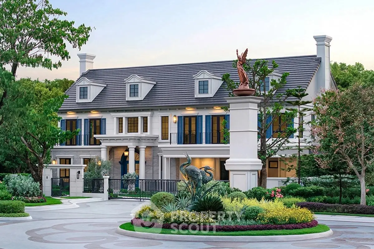 Luxurious mansion with elegant landscaping and grand entrance in serene neighborhood.