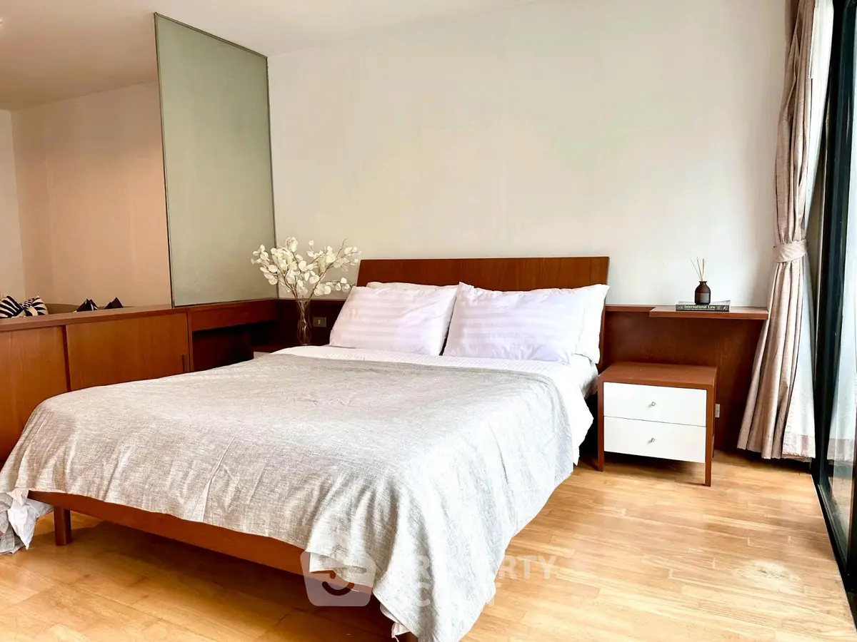 Spacious bedroom with modern wooden furniture and natural light