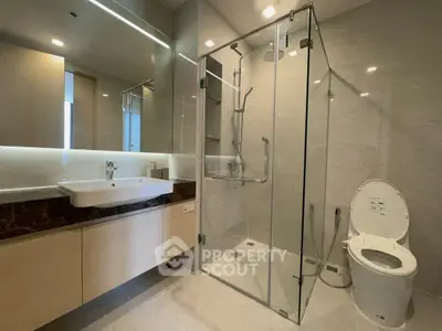 Luxurious modern bathroom with glass shower and elegant fixtures